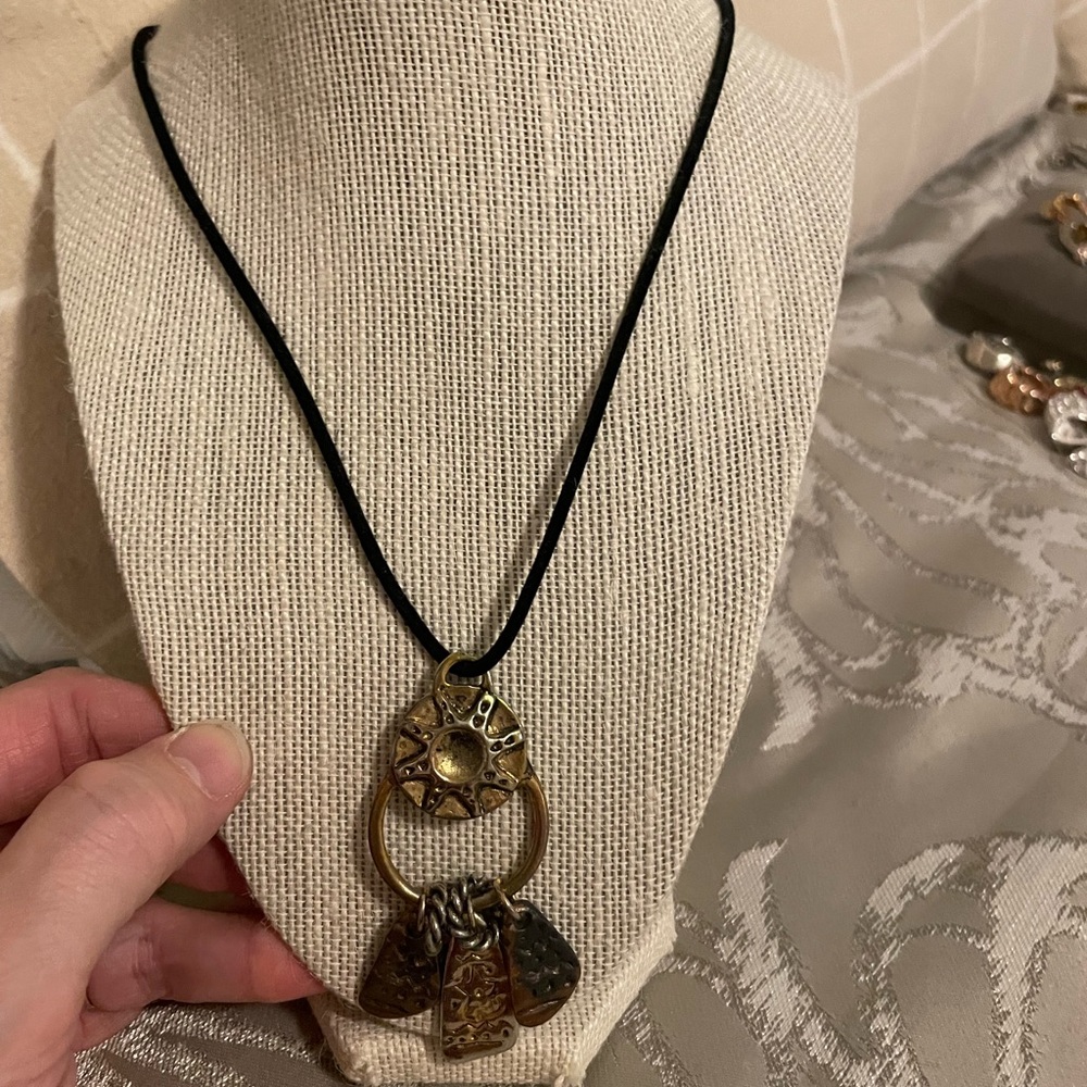 Black cord necklace with multi metal pendant